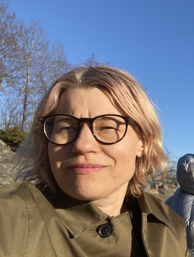 Emilie on a clear sunny day, wearing glasses